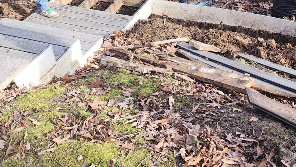 Rotten wood being replaced under the deck